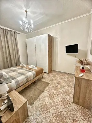 a bedroom with a bed and a flat screen tv at Maison Grimaldi Roma in Rome