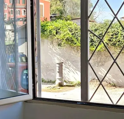 an open window with a view of a street at La finestra sul Nasone in Rome