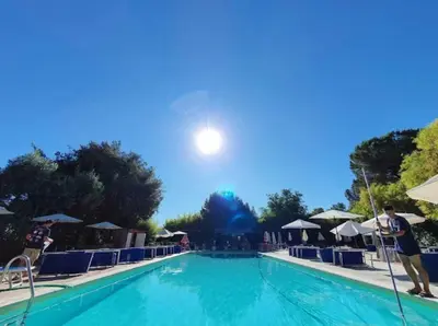 a large swimming pool with chairs and umbrellas at La finestra sul Nasone in Rome