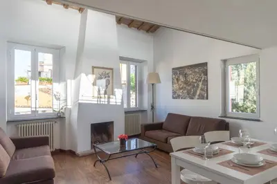 a living room with a couch and a fireplace at Lusso e panorama senza paragoni, Loft Trastevere in Rome