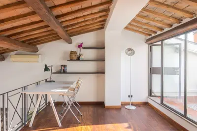 a dining room with a table and chairs and a window at Lusso e panorama senza paragoni, Loft Trastevere in Rome