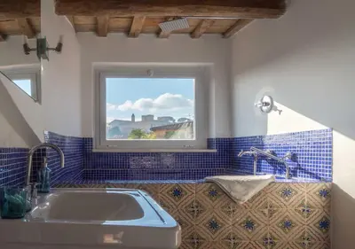 a bathroom with a sink and a window at Lusso e panorama senza paragoni, Loft Trastevere in Rome
