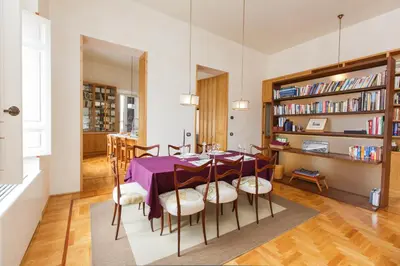a dining room with a purple table and chairs at Habitat's Navona 4BR Apartment in Rome