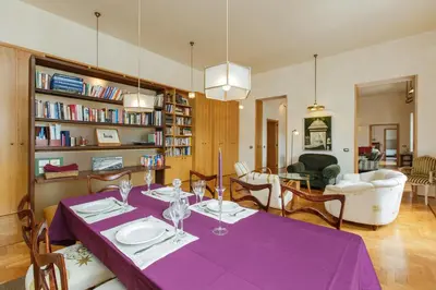 a dining room with a table with purple table cloth at Habitat's Navona 4BR Apartment in Rome