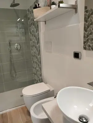 a bathroom with a toilet and a sink and a shower at 111 ColaDiRienzo Rooms - by AD Roma in Rome