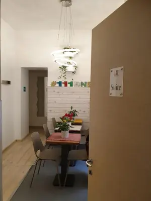 a dining room with a table and chairs and a chandelier at 111 ColaDiRienzo Rooms - by AD Roma in Rome