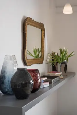 a shelf with two vases and a mirror on it at 111 ColaDiRienzo Rooms - by AD Roma in Rome