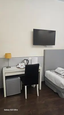 a bedroom with a desk and a bed with a bed gmaxwell gmaxwell gmaxwell at Caesar Place in Rome