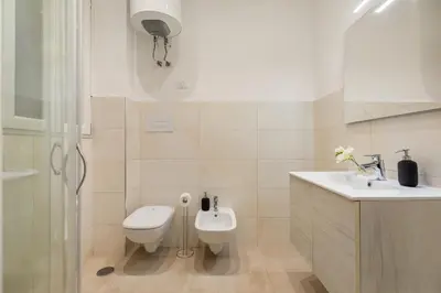a bathroom with a toilet and a sink and a shower at Homs Boutique Apartment in Rome