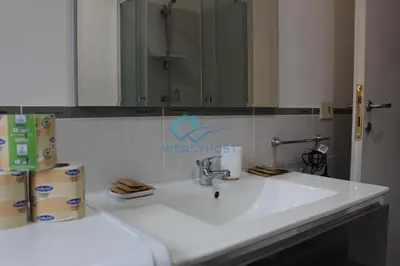 a bathroom with a white sink and a mirror at Cozy Haven near Caracalla Baths Your Home in San Giovanni in Rome
