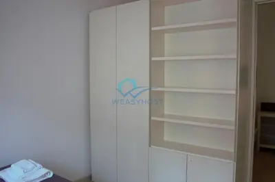 a closet with white shelves in a room at Cozy Haven near Caracalla Baths Your Home in San Giovanni in Rome