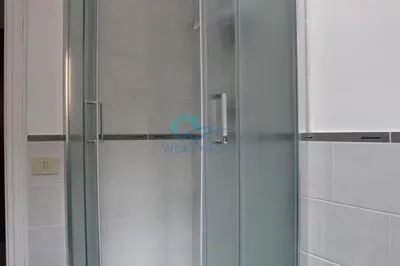 a shower with a glass door in a bathroom at Cozy Haven near Caracalla Baths Your Home in San Giovanni in Rome