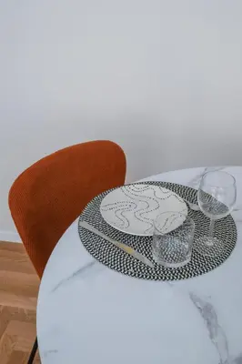 a table with a plate and two glasses on it at Prati Zen Boutique Studio-ZEN37 in Rome