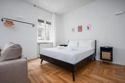 a white bedroom with a bed and a couch at Prati Zen Boutique Studio-ZEN37 in Rome