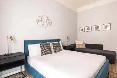 a bedroom with a bed and a couch at Donatello Boutique Apartment in Rome