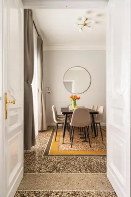 a dining room with a black table and chairs at Donatello Boutique Apartment in Rome