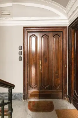 a wooden door with a rug in a room at Donatello Boutique Apartment in Rome