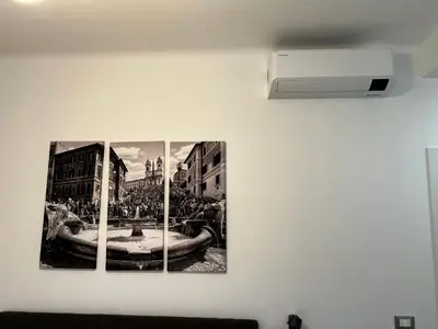 a wall with three pictures of a fountain at Love4Rome Guest House in Rome