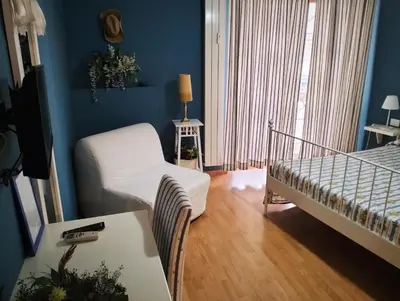 a bedroom with a bed and a chair in a room at Vista sul Tevere in Rome