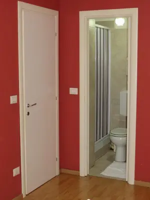 a bathroom with a toilet and red walls at Vista sul Tevere in Rome