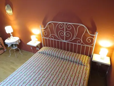 a bedroom with a bed with two tables and two lamps at Vista sul Tevere in Rome
