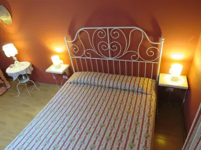 a bedroom with a bed with two lights on two tables at Vista sul Tevere in Rome