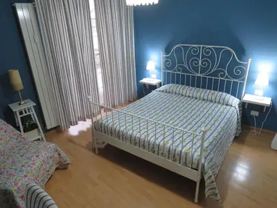 a bedroom with a bed and two tables with lamps at Vista sul Tevere in Rome