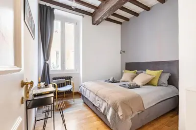 a bedroom with a bed and a table and chairs at Trastevere 68 Stylish Apartment in Rome