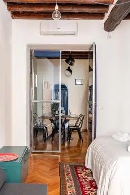 a bedroom with a table and chairs and a dining room at Trastevere 68 Stylish Apartment in Rome