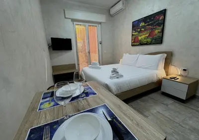 a bedroom with a bed and a table with a sink at La Palmetta - Vicino Metro A in Rome