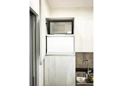 a kitchen with a microwave on top of a refrigerator at La Palmetta - Vicino Metro A in Rome