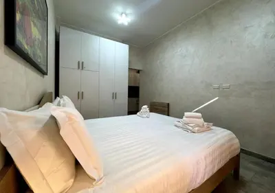 a bedroom with a large white bed in it at La Palmetta - Vicino Metro A in Rome