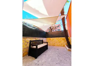 a tent with a bench in a patio at La Palmetta - Vicino Metro A in Rome