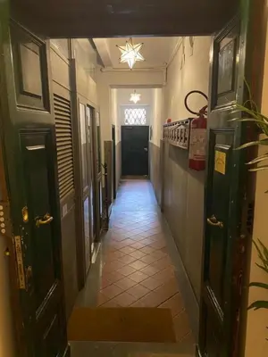 a hallway with a long hallway with a door and a room at NAVONA DOMITIA HOME in Rome