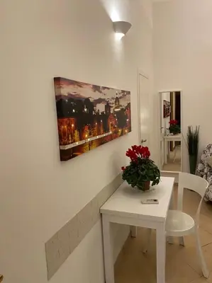 a room with a table and a painting on the wall at NAVONA DOMITIA HOME in Rome