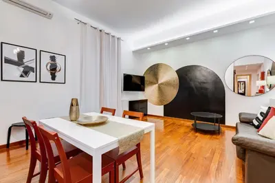 a living room with a table and chairs and a couch at BDC - Fancy 2-Bdr Apt @Vatican in Rome