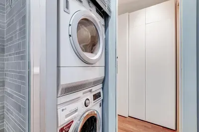 a washer and dryer in a white laundry room at BDC - Fancy 2-Bdr Apt @Vatican in Rome