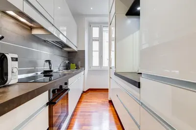 a kitchen with white cabinets and a microwave at BDC - Fancy 2-Bdr Apt @Vatican in Rome
