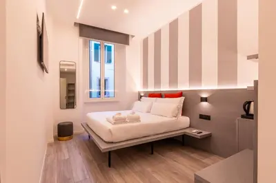 a bedroom with a bed and a window at Veneto Suite Roma in Rome