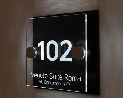 a sign on a door that reads vortexsie roma at Veneto Suite Roma in Rome
