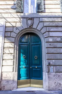 a blue door on the side of a building at Veneto Suite Roma in Rome