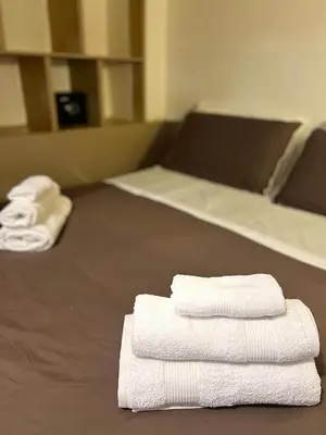three stacks of towels sitting on the floor of a room at Sapri Apartment - Castro Pretorio by GHOR in Rome