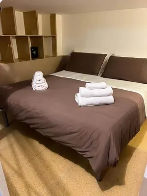 a bed with towels sitting on top of it at Sapri Apartment - Castro Pretorio by GHOR in Rome
