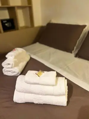 two folded towels on a table in a bathroom at Sapri Apartment - Castro Pretorio by GHOR in Rome