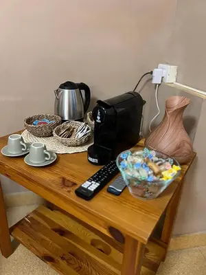 a table with a camera and a vase on it at Sapri Apartment - Castro Pretorio by GHOR in Rome