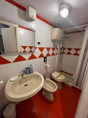 a bathroom with a sink and a toilet at Sapri Apartment - Castro Pretorio by GHOR in Rome
