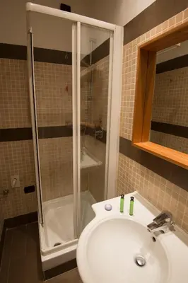 a bathroom with a shower and a white sink at My Rooms in Rome
