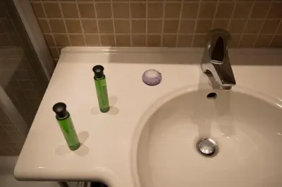two toothbrushes sitting on top of a white sink at My Rooms in Rome