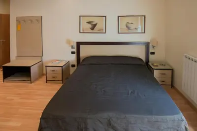 a bedroom with a large bed and two night stands at My Rooms in Rome