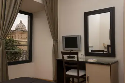a room with a desk with a mirror and a television at My Rooms in Rome